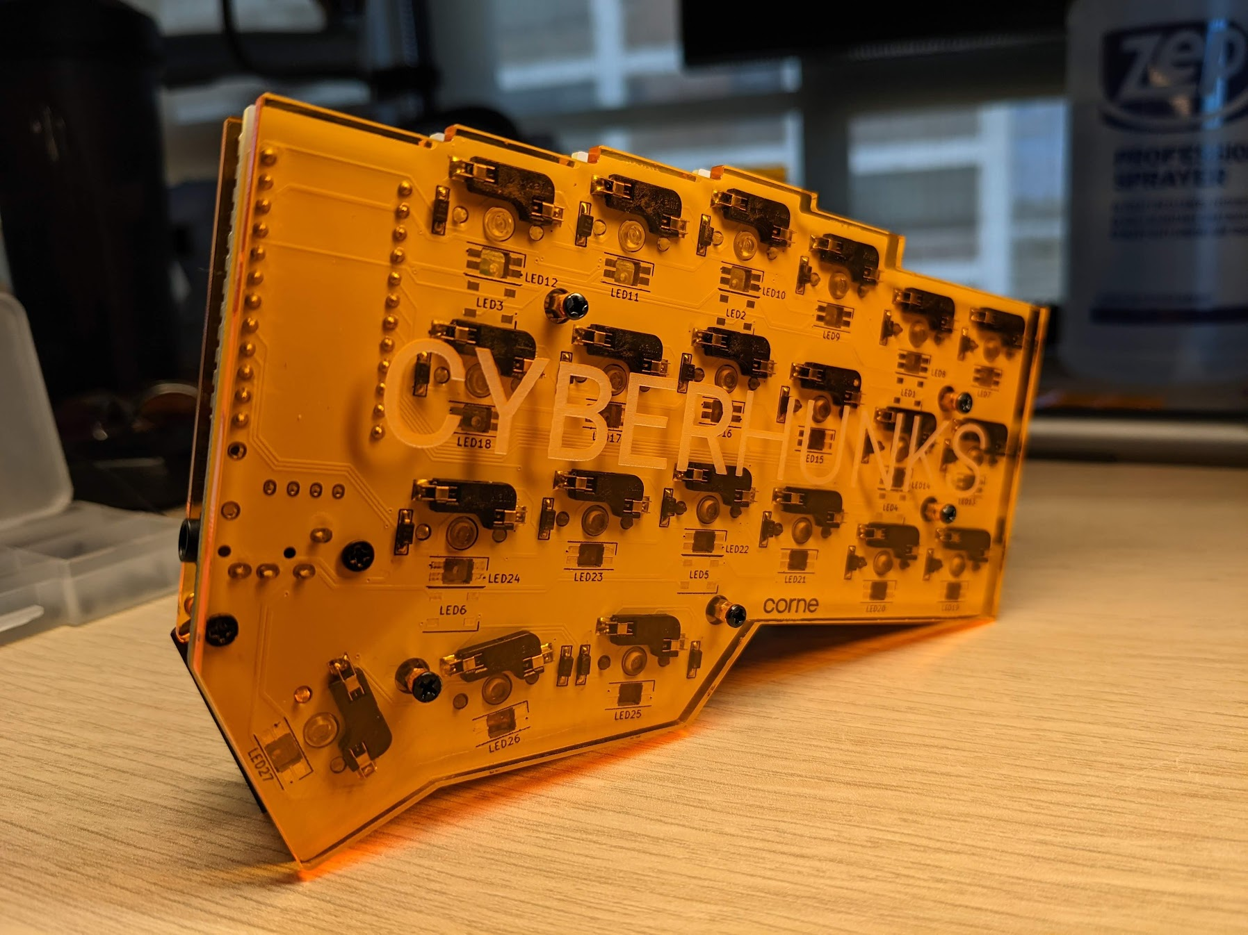 Orange translucent Corne underside with visible PCB and components